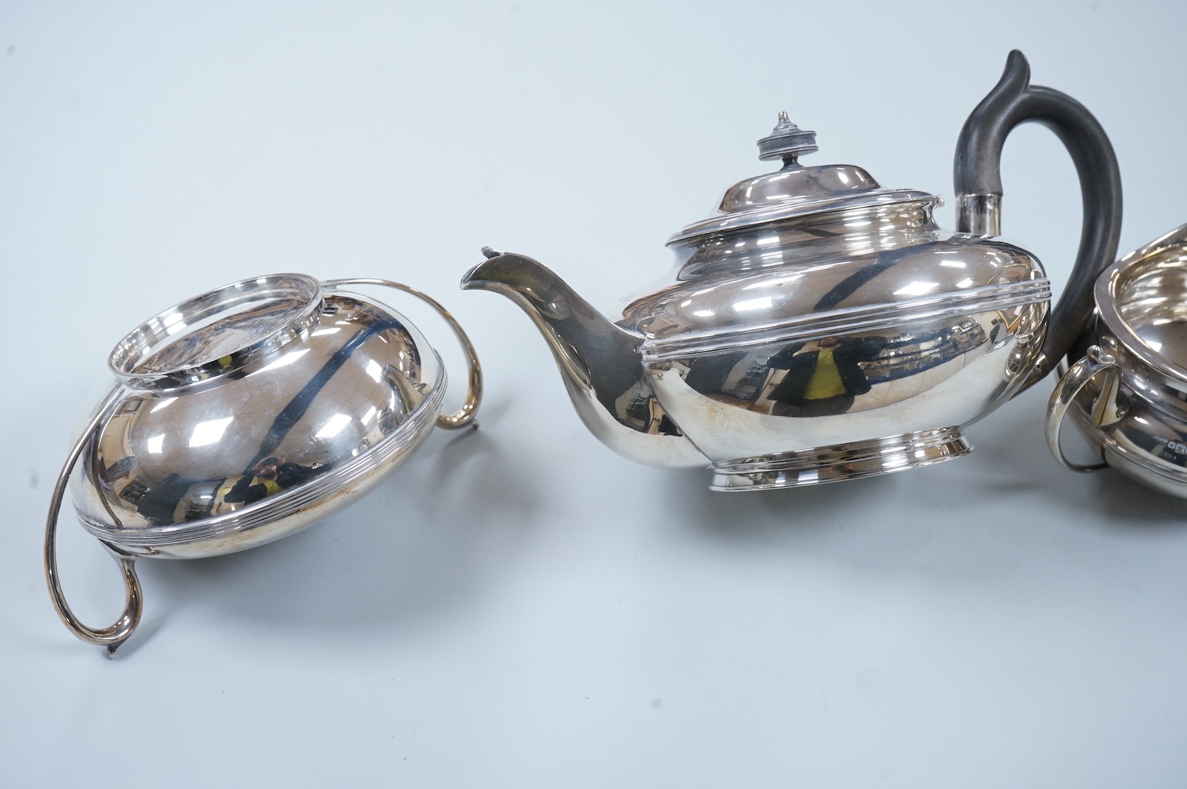 A George V three piece silver tea set, each piece of compressed globular form by James Dixon and Sons, Sheffield 1910, 1025g gross